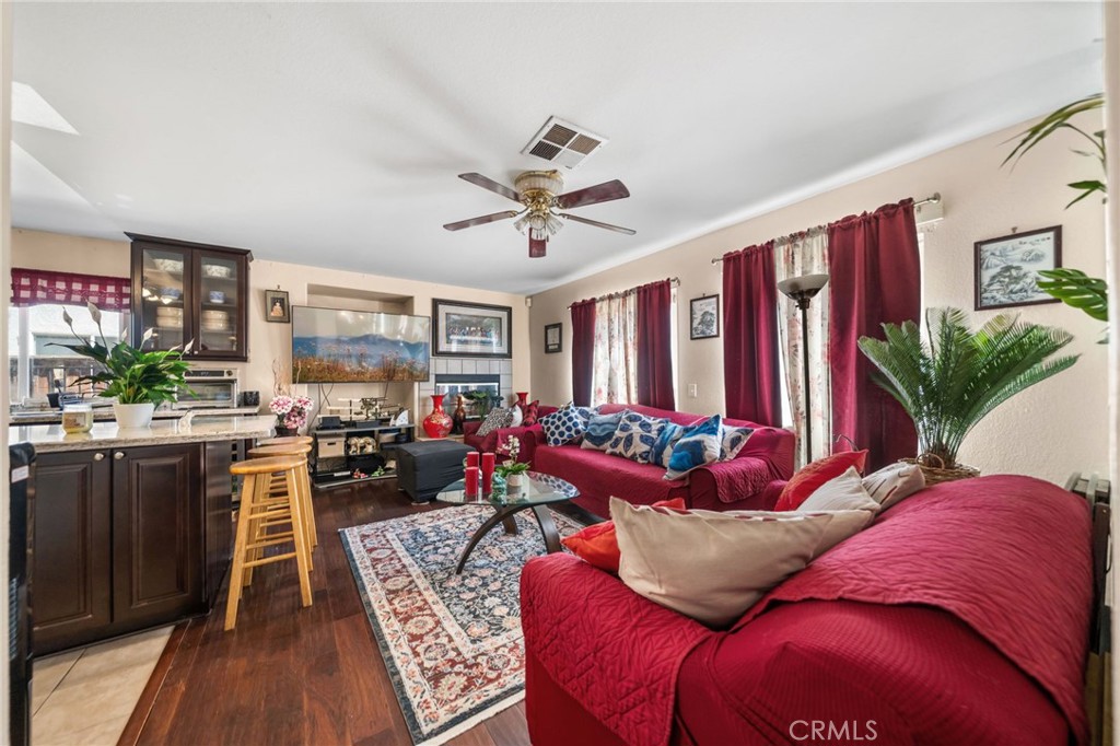 4475 Willowglen Way Hemet, CA 92545 - Photo 15 of 33 a living room with furniture floor to ceiling window and a flat screen tv