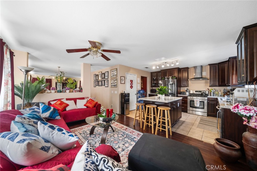 4475 Willowglen Way Hemet, CA 92545 - Photo 16 of 33 a living room with furniture kitchen view and a chandelier