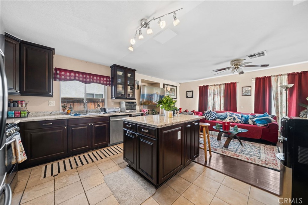 4475 Willowglen Way Hemet, CA 92545 - Photo 18 of 33 a kitchen with a stove top oven and cabinets