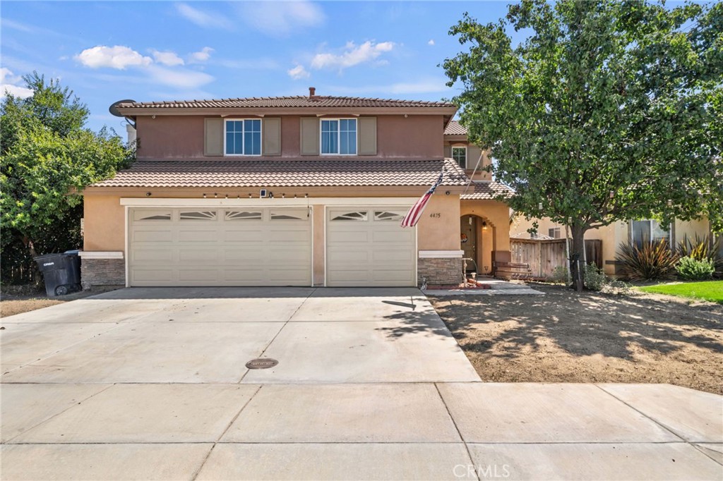4475 Willowglen Way Hemet, CA 92545 - Photo 5 of 33 a front view of a house with a yard and garage