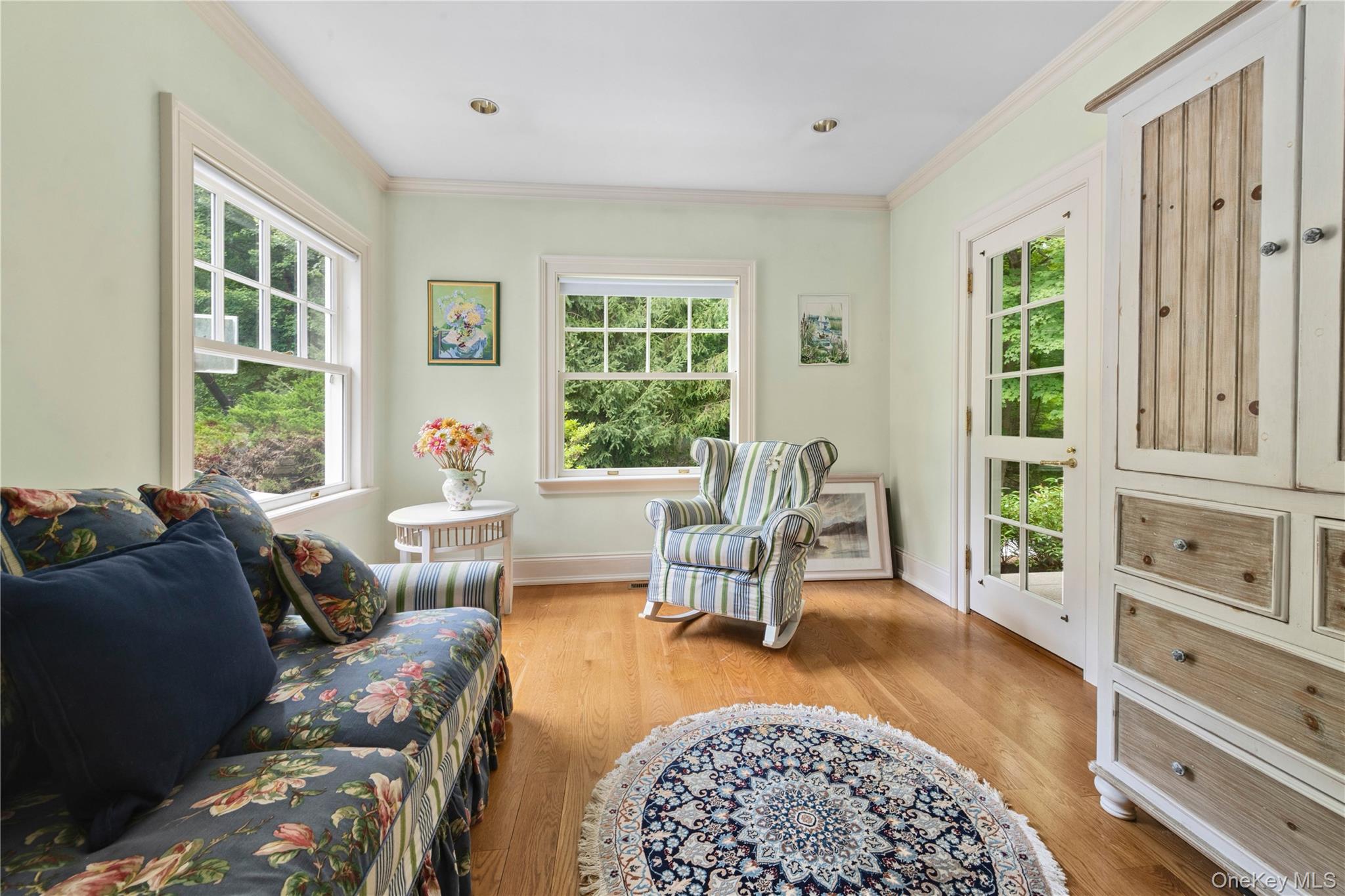 284 West Patent Road Bedford, NY 10549 - Photo 22 of 40 Living area with light wood-style floors and ornamental molding