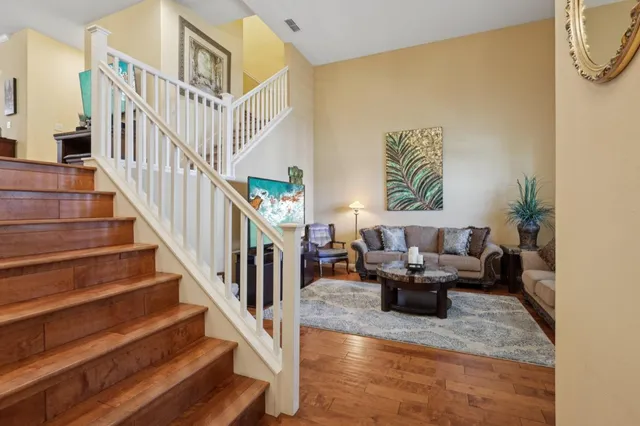 a living room with fireplace furniture and a potted plant