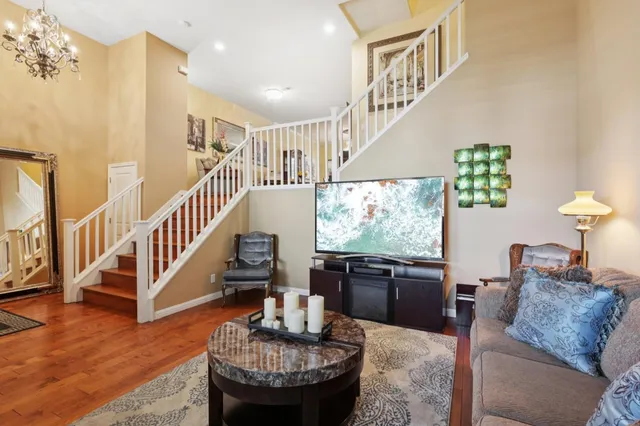 a living room with furniture and a dining table