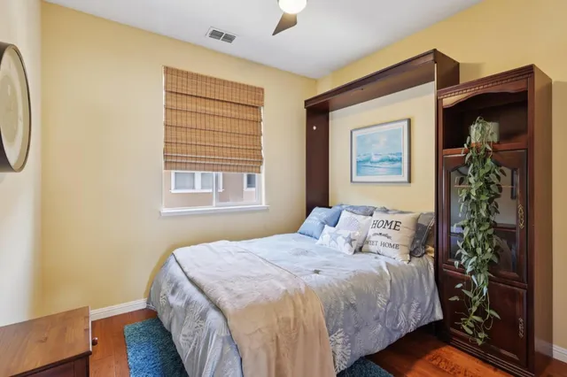 a bedroom with a bed and a potted plant