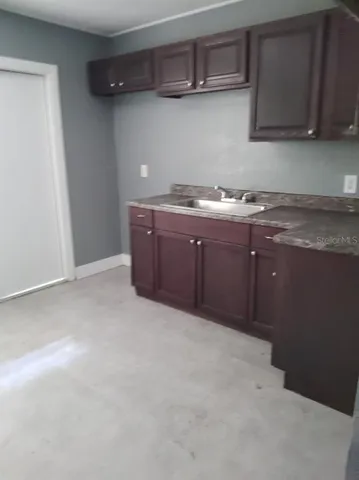 a room with granite countertop cabinets and a sink