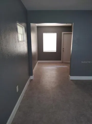 an empty room that has a window in it