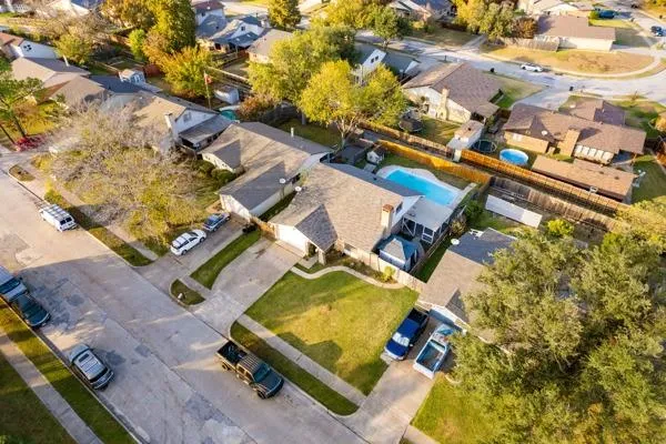 an aerial view of a house with a yard and lake view
