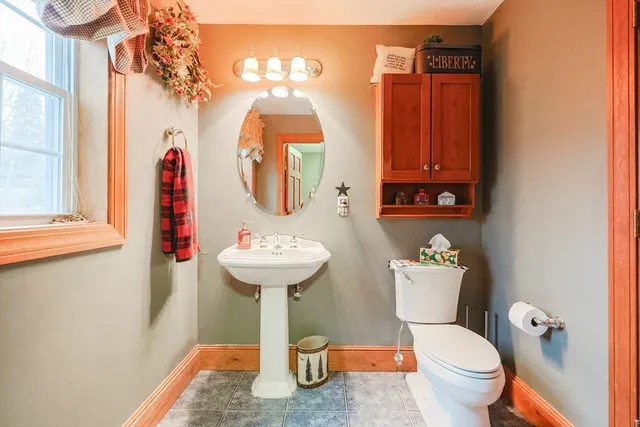 a bathroom with a toilet sink and mirror