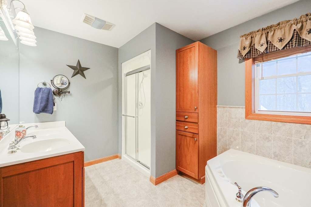11 Brigham Road Paxton, MA 01612 - Photo 24 of 42 a bathroom with a tub sink and mirror