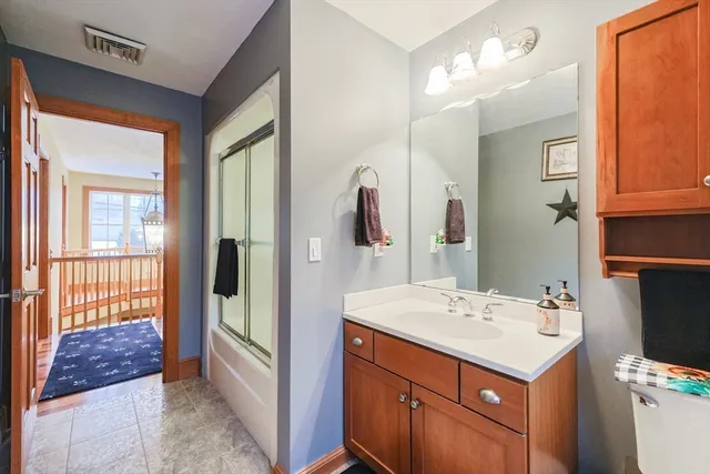 a bathroom with a sink a mirror and a shower