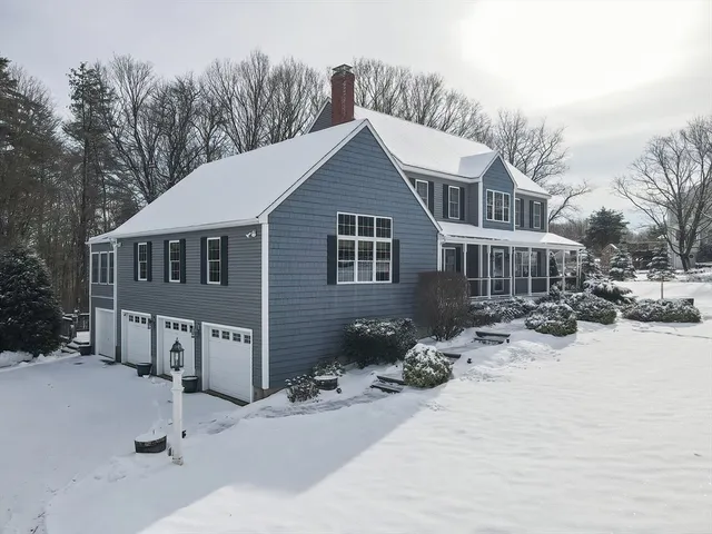a view of a house with a yard covered in snow