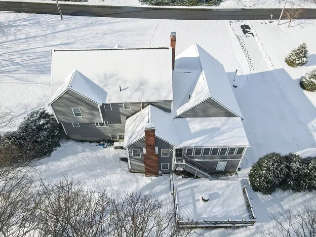 an aerial view of a house with a yard and sitting space