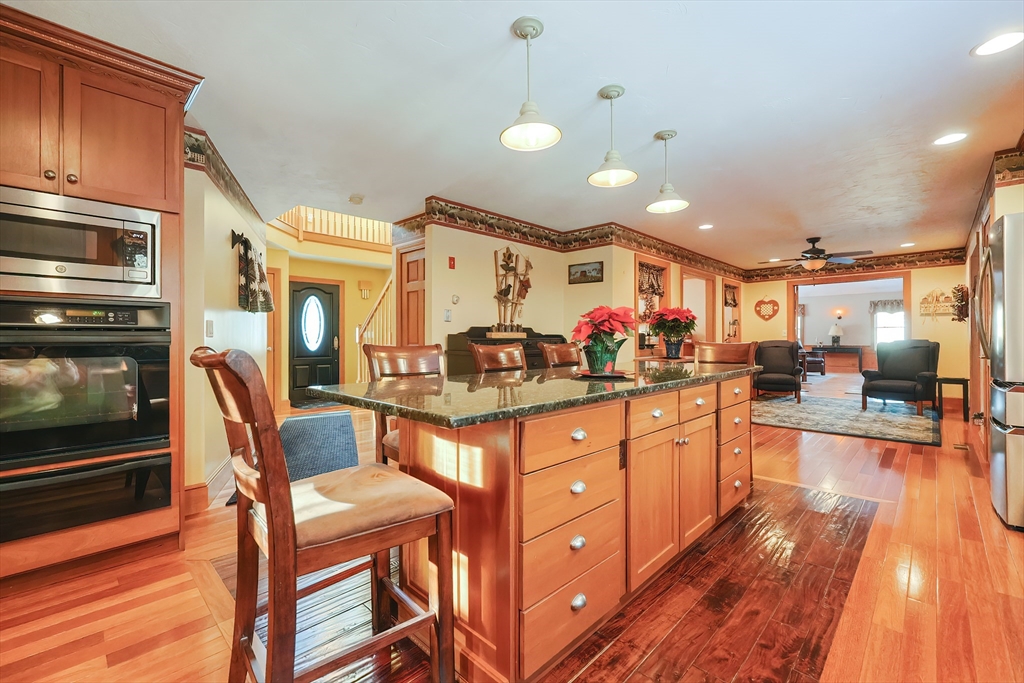 11 Brigham Road Paxton, MA 01612 - Photo 7 of 42 a kitchen with stainless steel appliances kitchen island granite countertop a stove and cabinets