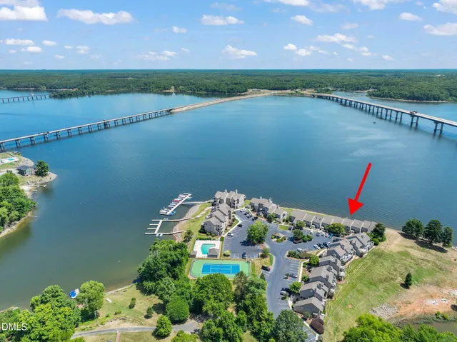an aerial view of a house with a yard and lake view