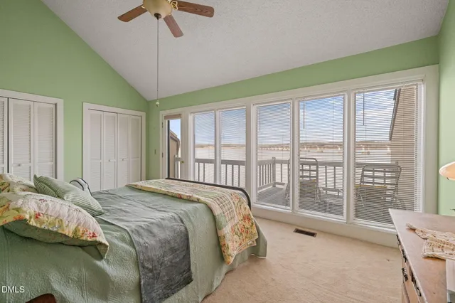 a bed sitting in a bedroom next to a balcony
