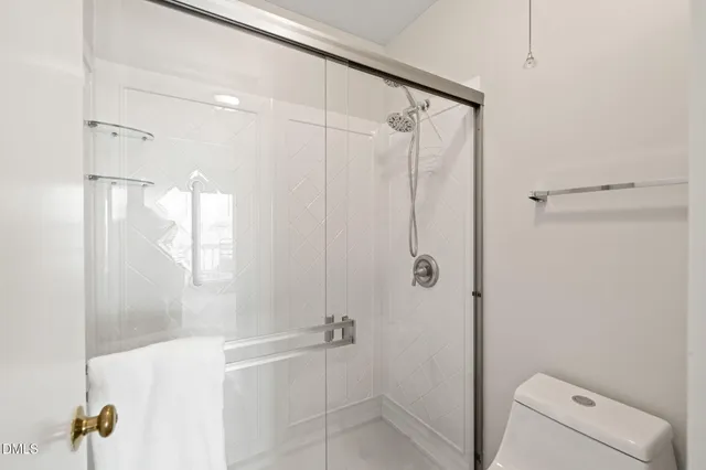 a bathroom with a shower and a toilet