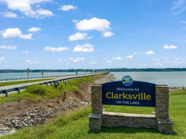 a view of a lake with couches table and chairs