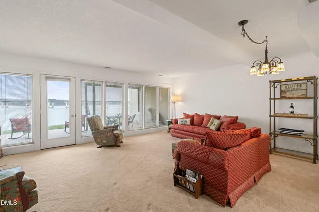 a living room with furniture and large windows