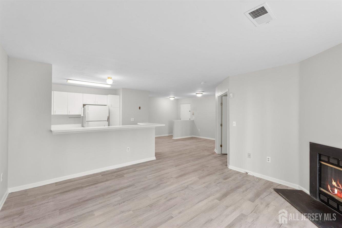 724 Edpas Road New Brunswick, NJ 08901 - Photo 11 of 24 a view of kitchen and empty room with wooden floor