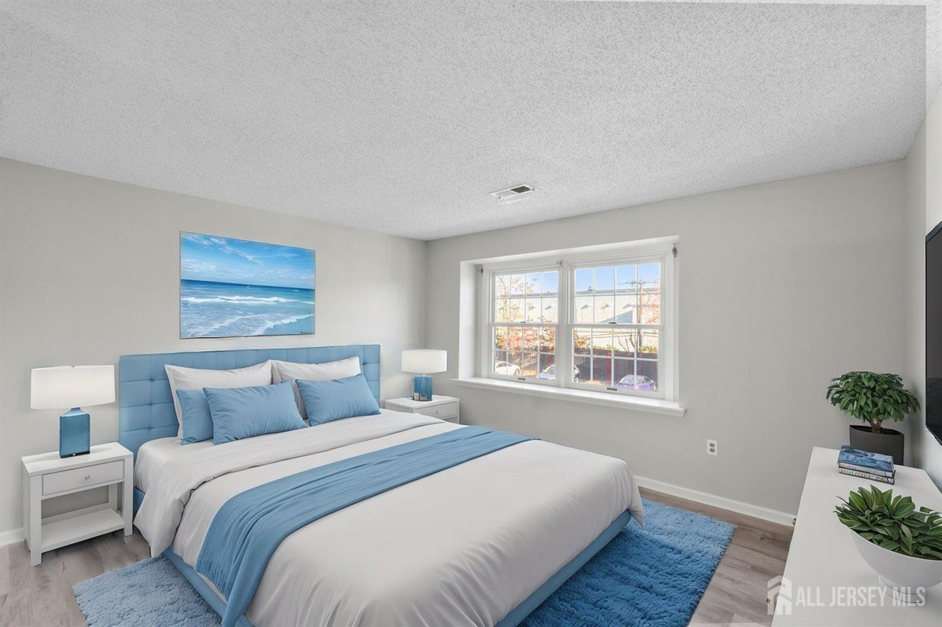 724 Edpas Road New Brunswick, NJ 08901 - Photo 15 of 24 a bedroom with a large bed and a window