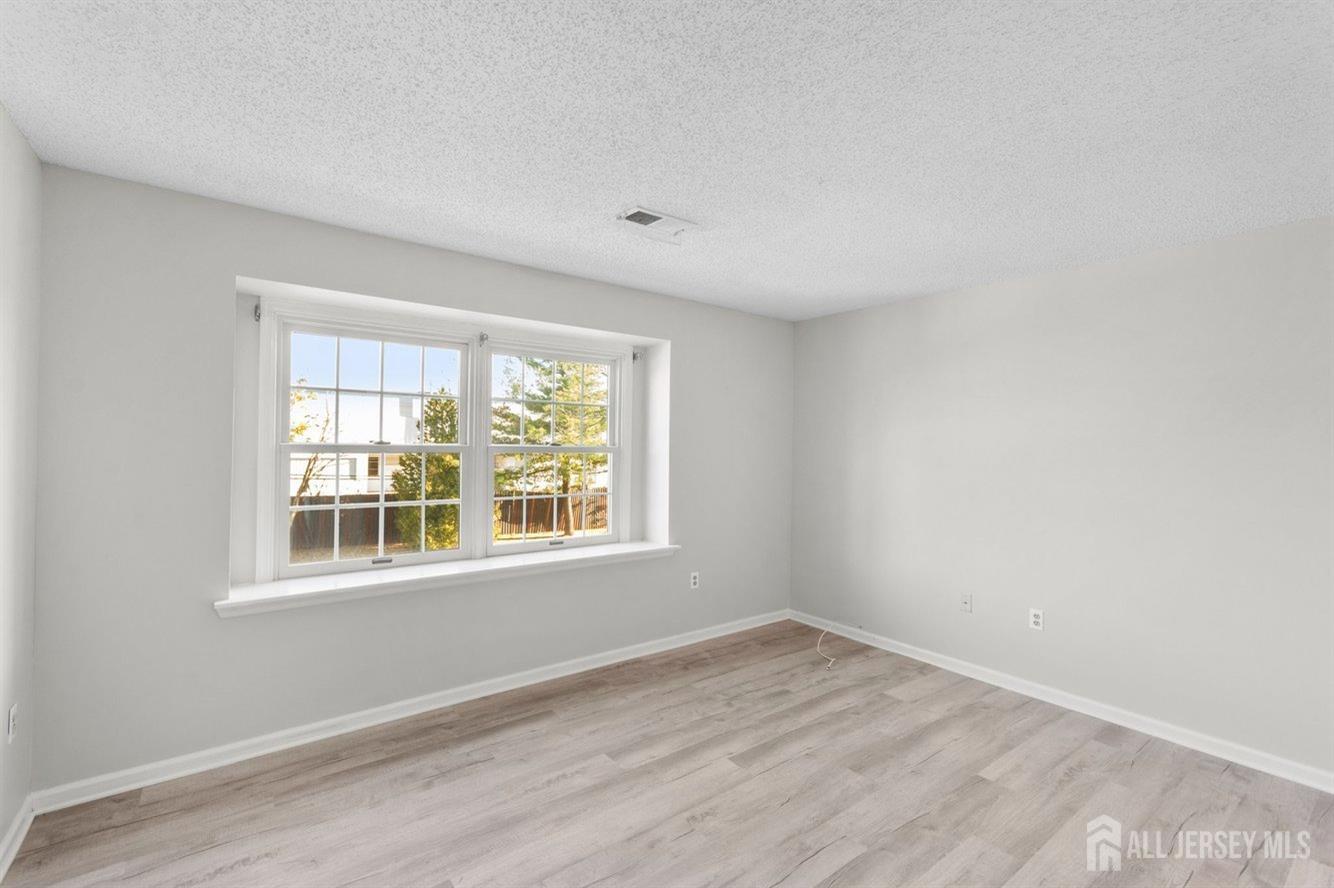 724 Edpas Road New Brunswick, NJ 08901 - Photo 21 of 24 a view of empty room with wooden floor and fan