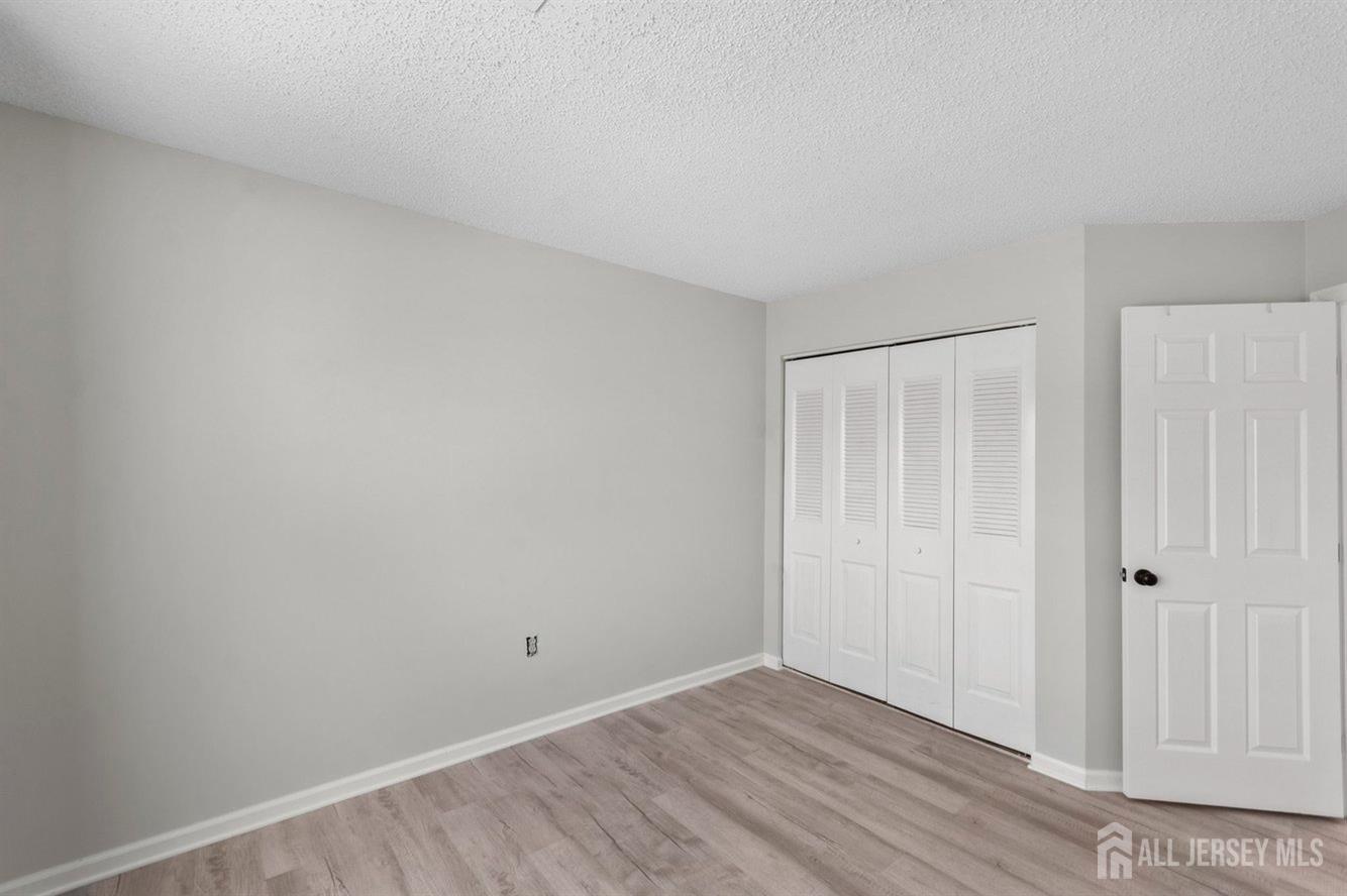 724 Edpas Road New Brunswick, NJ 08901 - Photo 22 of 24 a view of an empty room with wooden floor