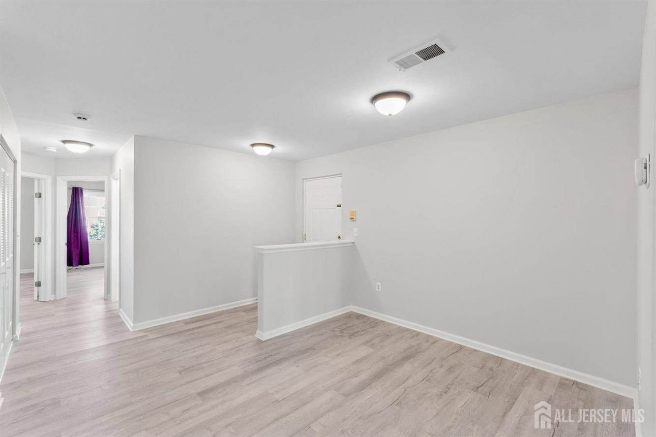 724 Edpas Road New Brunswick, NJ 08901 - Photo 3 of 24 a view of a room with wooden floor and natural light