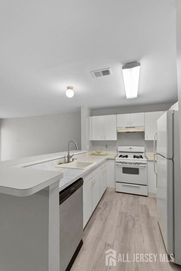 724 Edpas Road New Brunswick, NJ 08901 - Photo 7 of 24 a kitchen with a stove a sink and a refrigerator