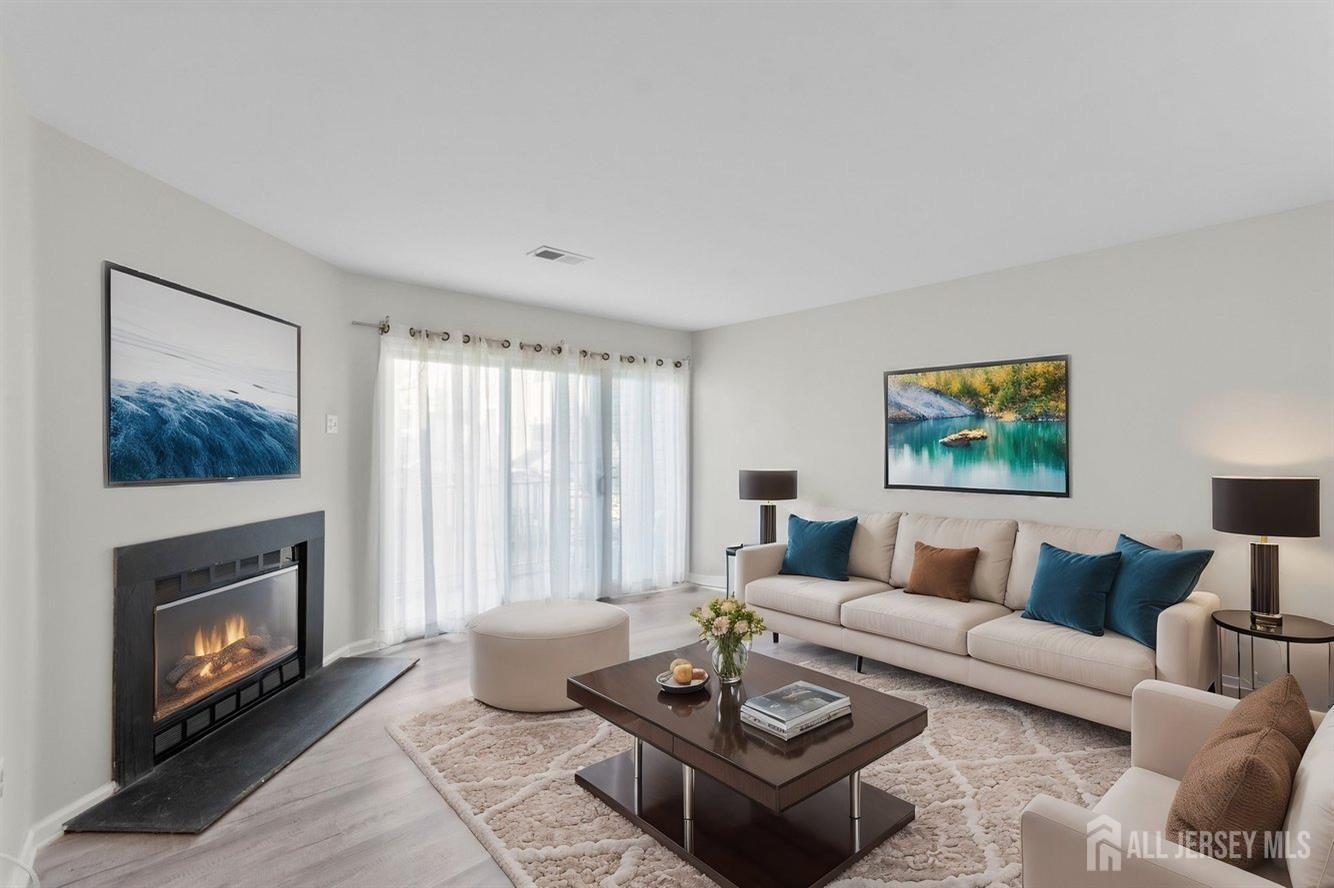 724 Edpas Road New Brunswick, NJ 08901 - Photo 8 of 24 a living room with furniture a fireplace and a large window