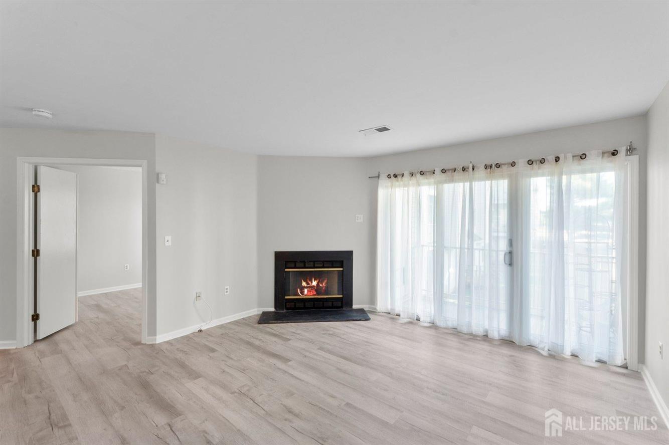 724 Edpas Road New Brunswick, NJ 08901 - Photo 10 of 24 an empty room with windows and fireplace