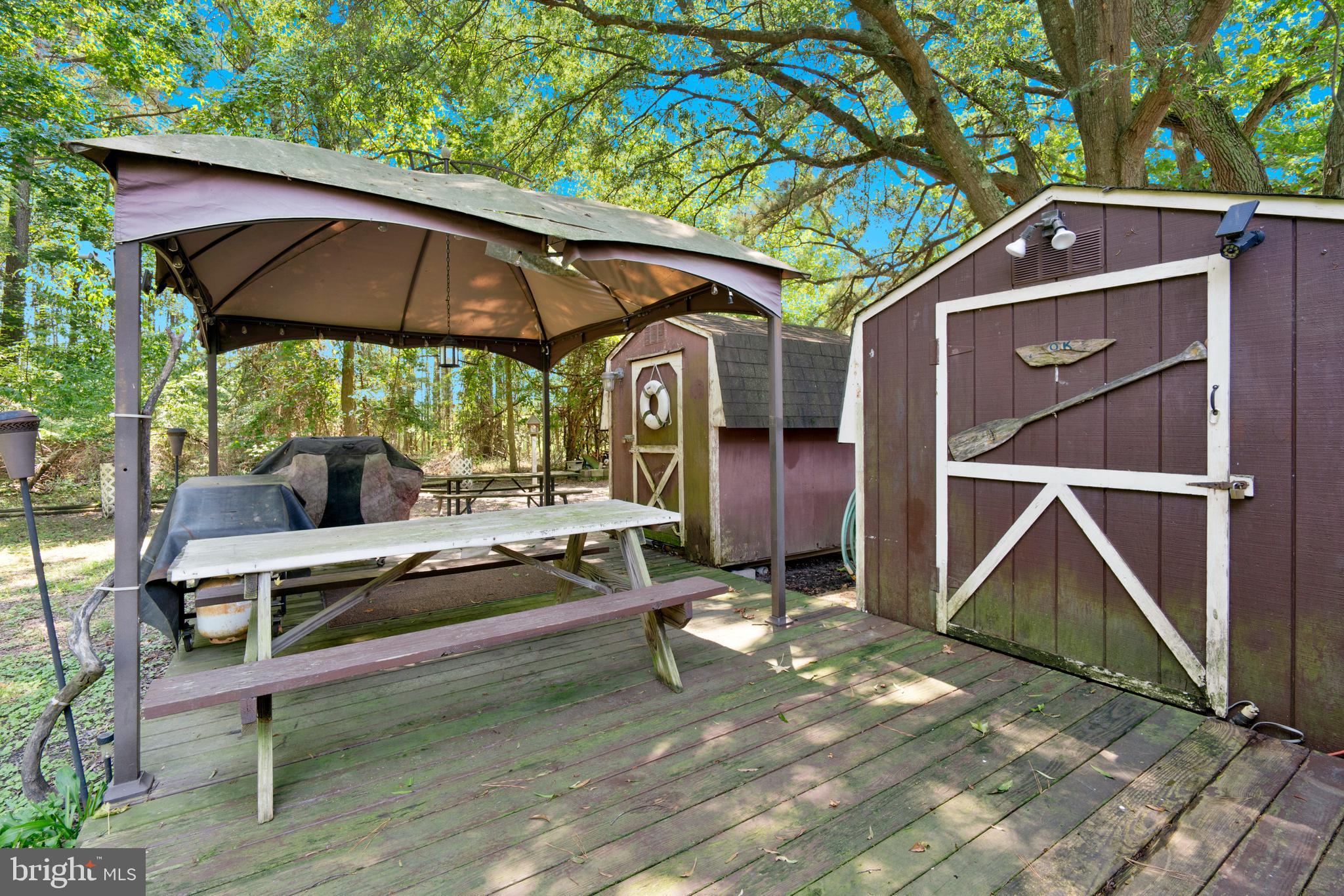 111 Beach Harbor Road, Unit 11F Grasonville, MD 21638 - Photo 13 of 13 a backyard of a house with barbeque oven table and chairs