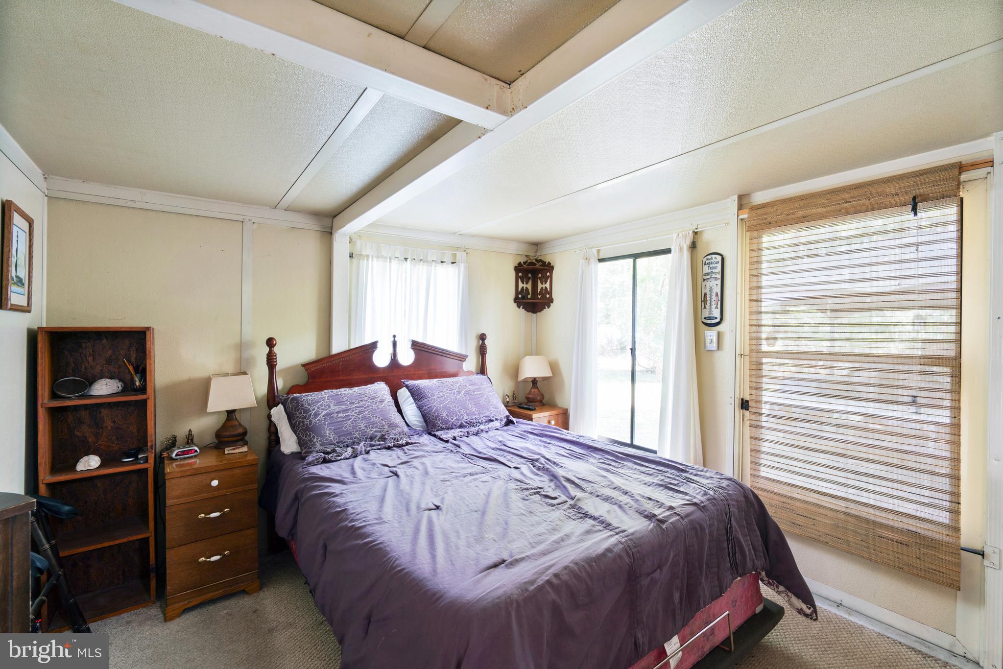 111 Beach Harbor Road, Unit 11F Grasonville, MD 21638 - Photo 7 of 13 a bedroom with a bed and a window