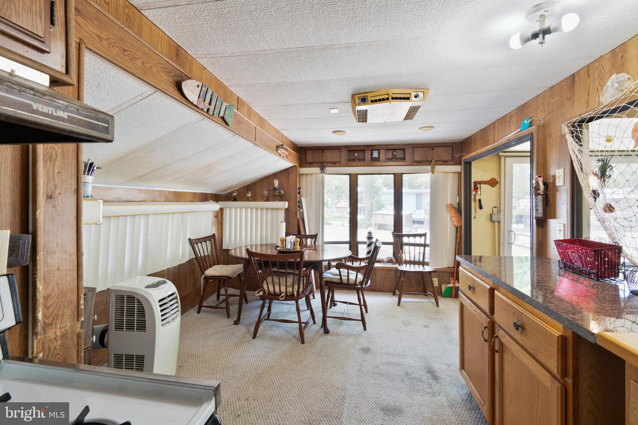 111 Beach Harbor Road, Unit 11F Grasonville, MD 21638 - Photo 9 of 13 a view of a dining room with furniture window and outside view