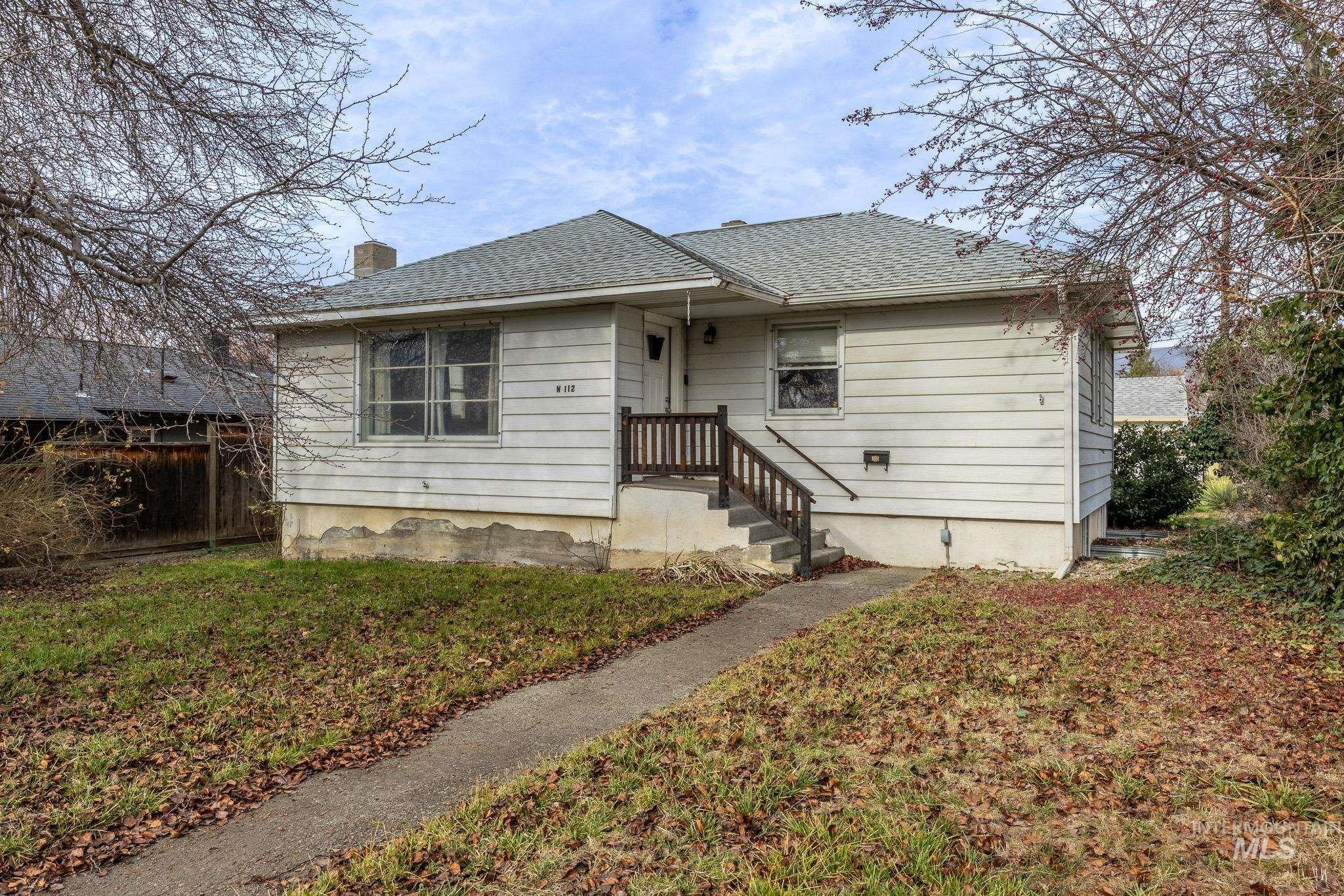 112 18th Avenue Lewiston, ID 83501 - Photo 1 of 1 Bungalow-style house with a shingled roof and a chimney