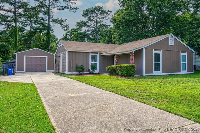 a front view of house with yard and green space