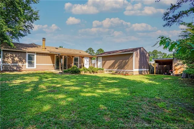 a view of a house with a backyard