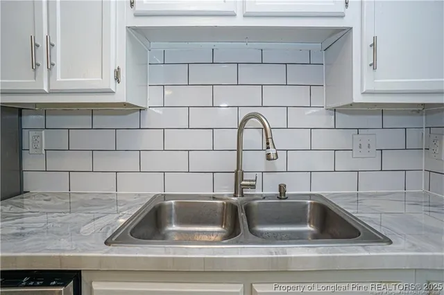a kitchen with a sink and cabinets