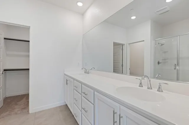 a spacious bathroom with a granite countertop sink mirror and a
