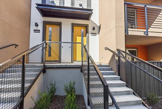 a view of a balcony with wooden floor and fence