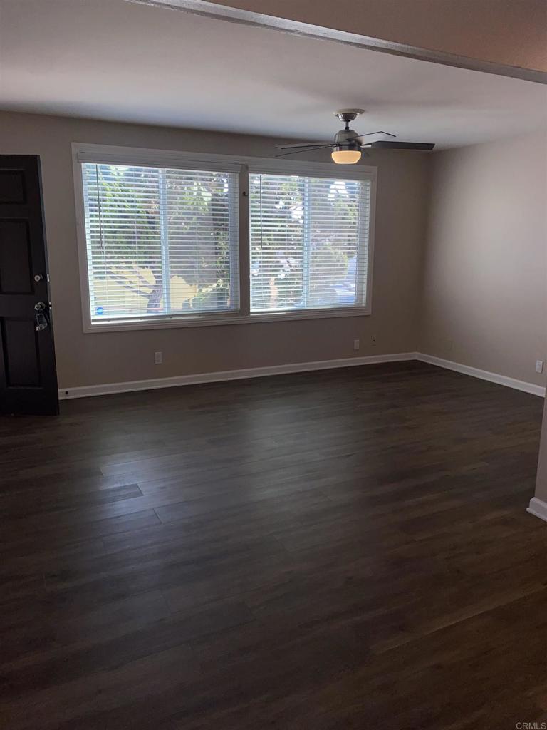 2088 Montgomery Avenue, Unit M Cardiff-by-the-Sea, CA 92007 - Photo 11 of 43 an empty room with wooden floor and windows