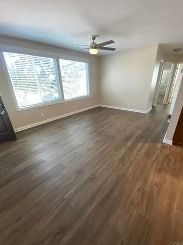 wooden floor in an empty room with a window