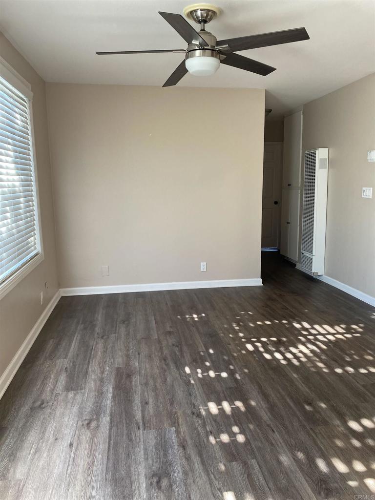 2088 Montgomery Avenue, Unit M Cardiff-by-the-Sea, CA 92007 - Photo 14 of 43 an empty room with wooden floor and windows