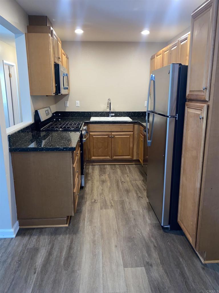 2088 Montgomery Avenue, Unit M Cardiff-by-the-Sea, CA 92007 - Photo 17 of 43 a kitchen with granite countertop a refrigerator and a sink