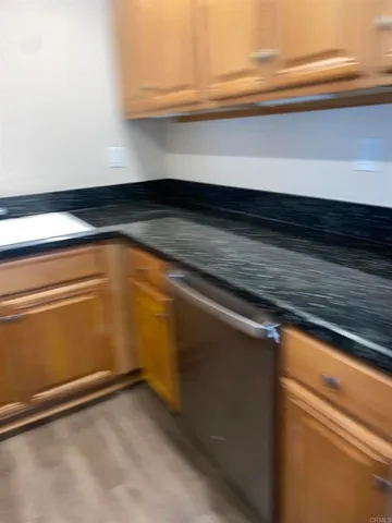 a kitchen with granite countertop stainless steel appliances a refrigerator a sink a stove a microwave and cabinets