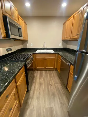 a stove top oven sitting inside of a kitchen
