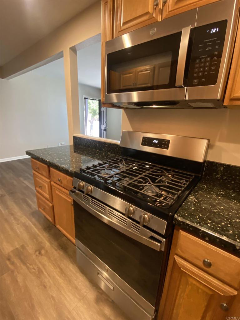 2088 Montgomery Avenue, Unit M Cardiff-by-the-Sea, CA 92007 - Photo 22 of 43 a stove top oven sitting inside of a kitchen