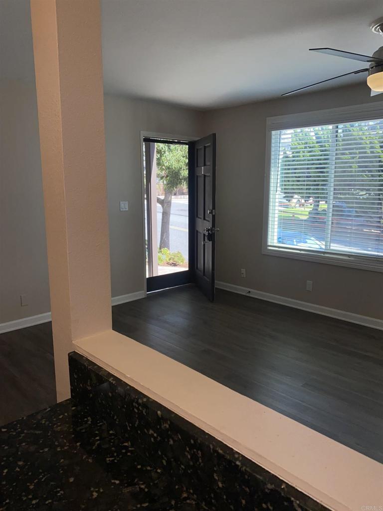 2088 Montgomery Avenue, Unit M Cardiff-by-the-Sea, CA 92007 - Photo 24 of 43 an empty room with wooden floor and windows