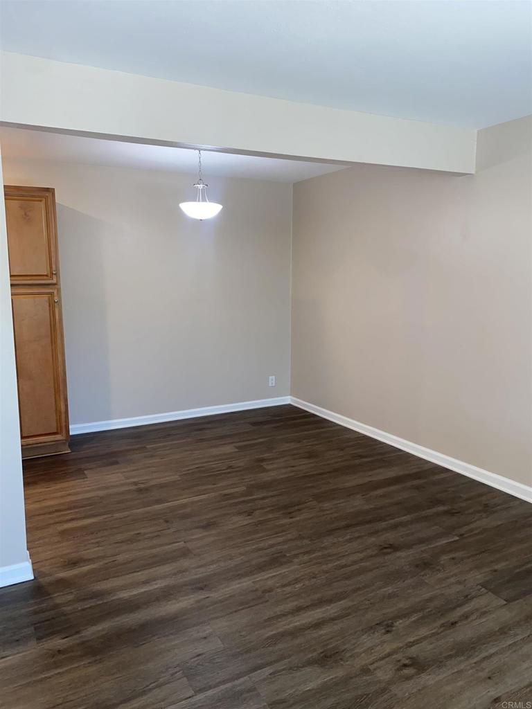 2088 Montgomery Avenue, Unit M Cardiff-by-the-Sea, CA 92007 - Photo 25 of 43 a view of an empty room with wooden floor and a window