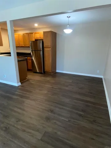 a view of an empty room and wooden floor