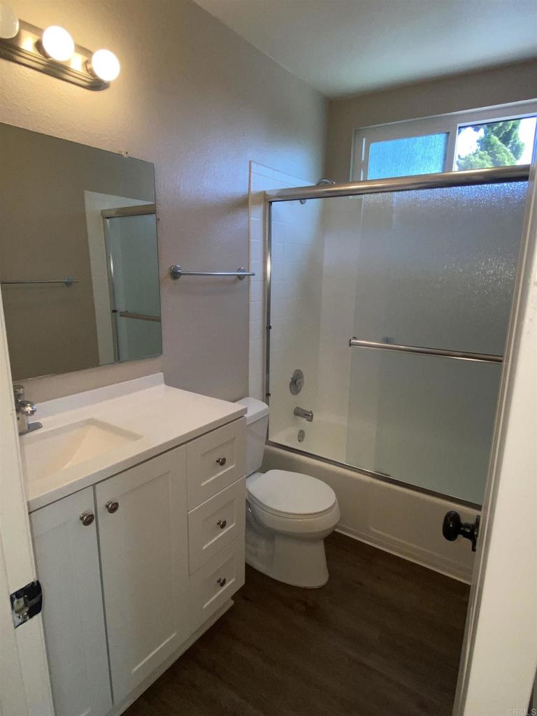 2088 Montgomery Avenue, Unit M Cardiff-by-the-Sea, CA 92007 - Photo 40 of 43 a bathroom with a granite countertop sink toilet a mirror and shower